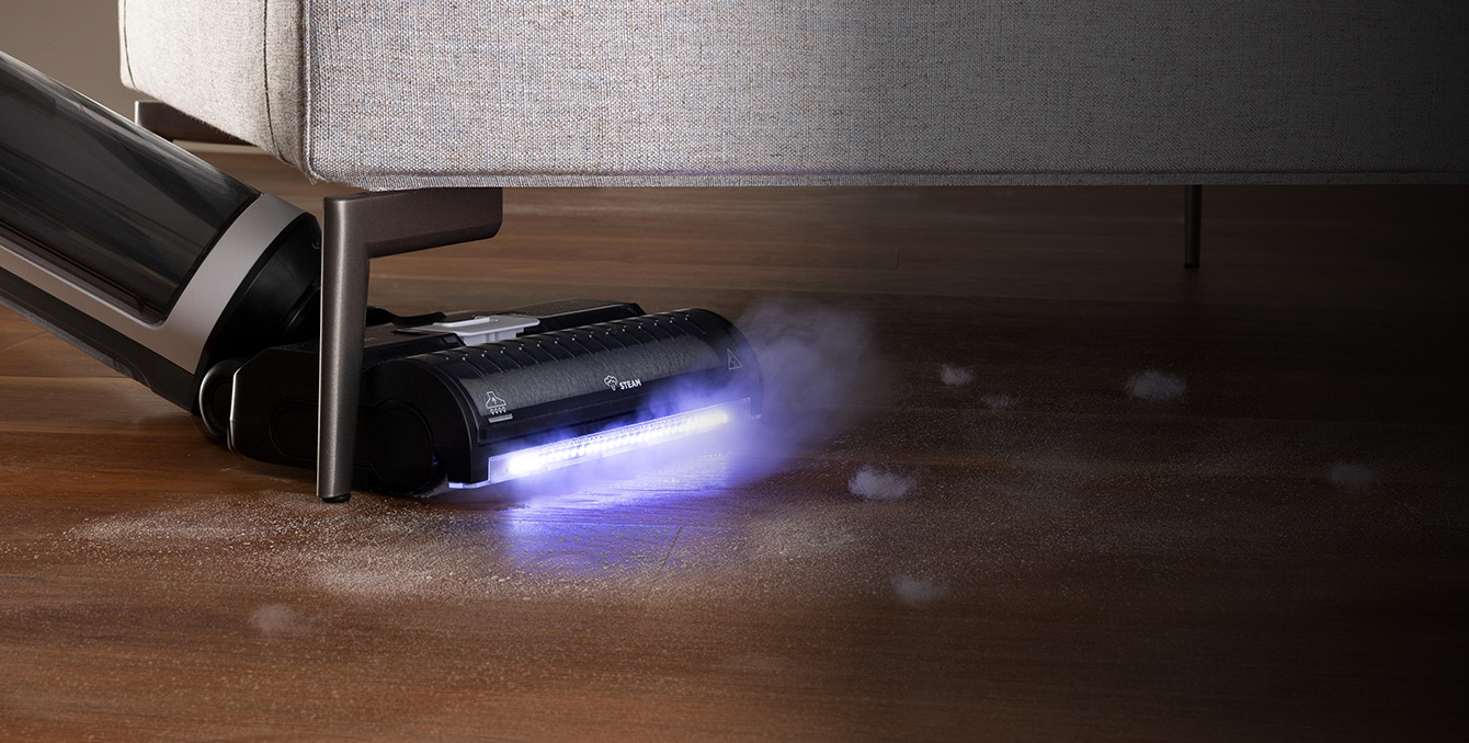 Polti RollySteam cleaning under a sofa